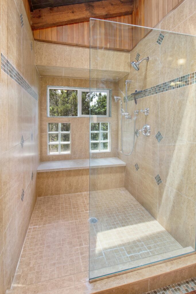 Spacious, elegant shower with glass doors and natural light for a contemporary home feel.